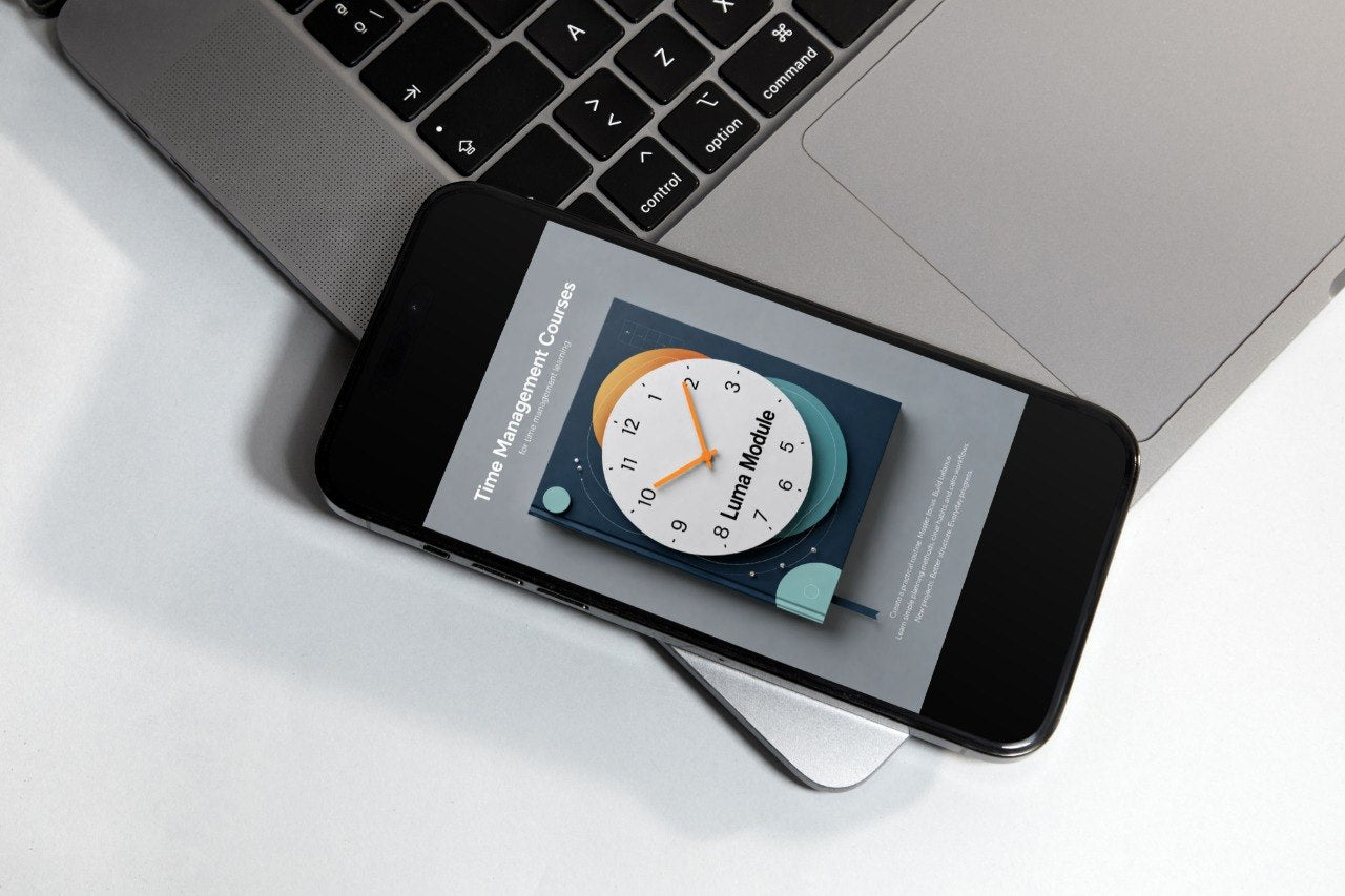 Smartphone displaying a clock app on a laptop keyboard